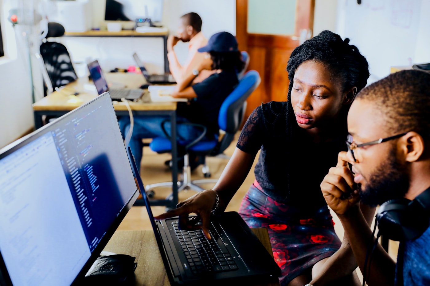 Colleagues collaborating at a laptop